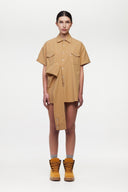 Beige shirt with 4 sleeves making a tie waist 